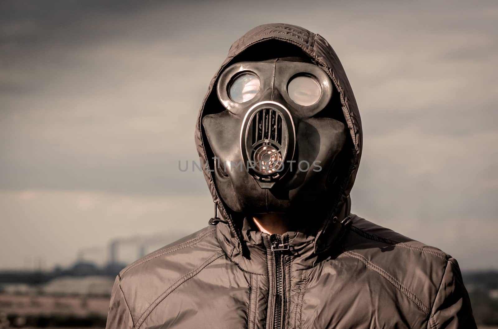 portrait of a man in a gas mask and a hood