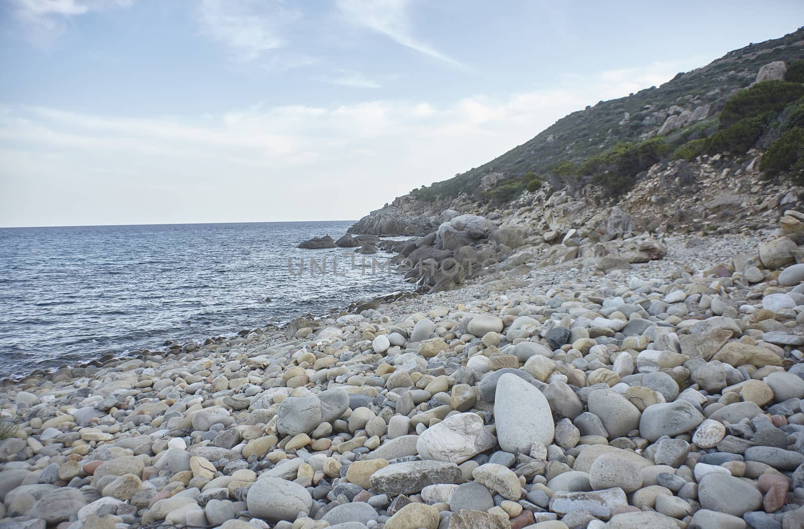 Magnificent view of Punta Molentis beach In Sardinia, taken during the summer: A completely uncontaminated and natural Mediterranean pebble beach.