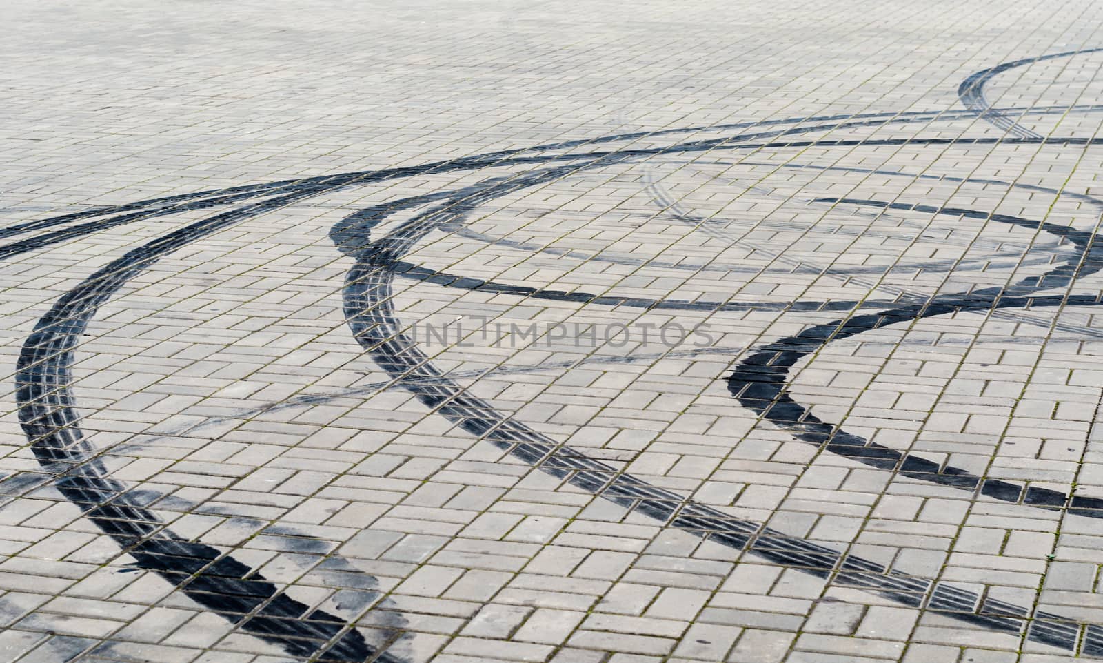 black marks of braking tires on car wheels on the road