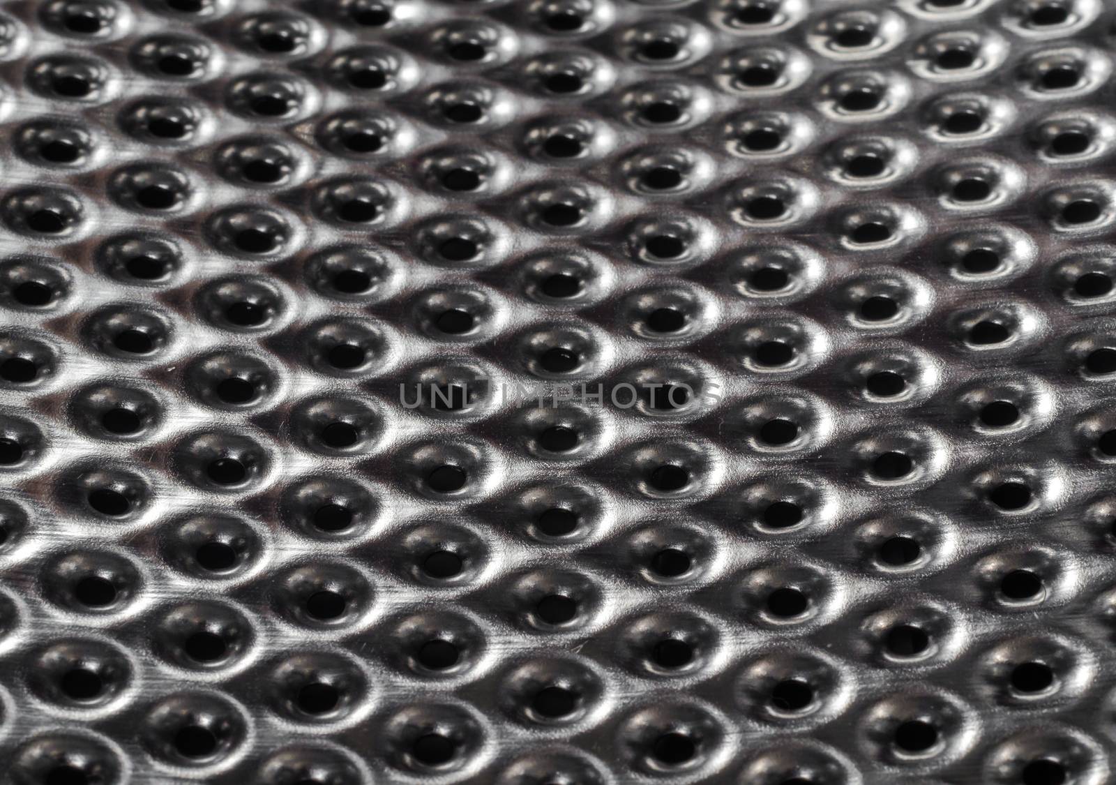 texture metal surface with a round perforation macro closeup