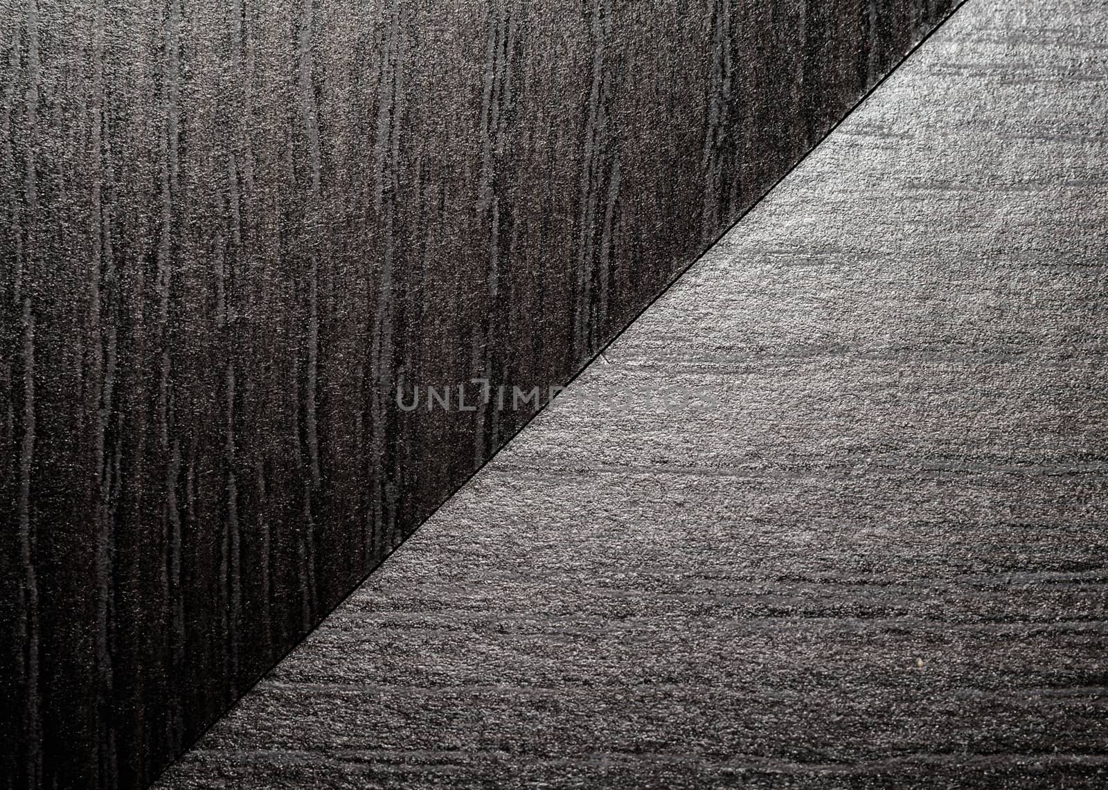 intersection of two black wooden surfaces closeup