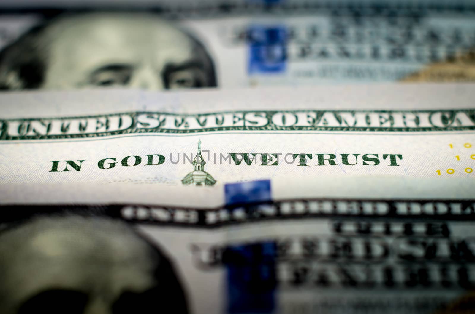 bill hundred US dollars closeup macro phrase in god we trust