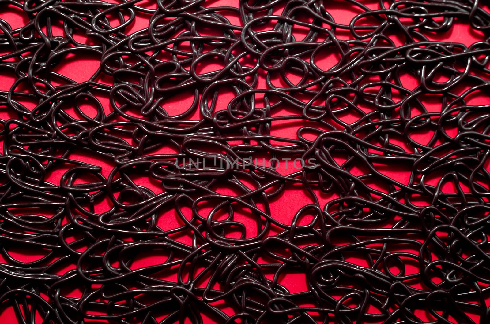 texture pattern of dark brown rubber on a red background
