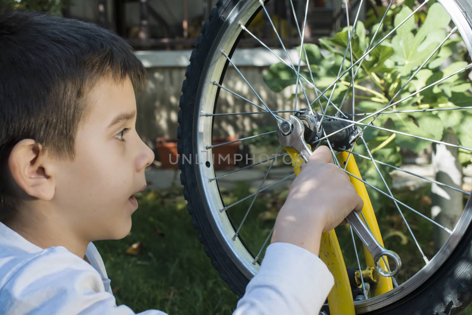 Child who fix bikes. Boy and bicycle