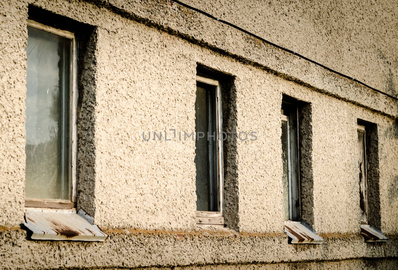 old dirty wall of a building with windows