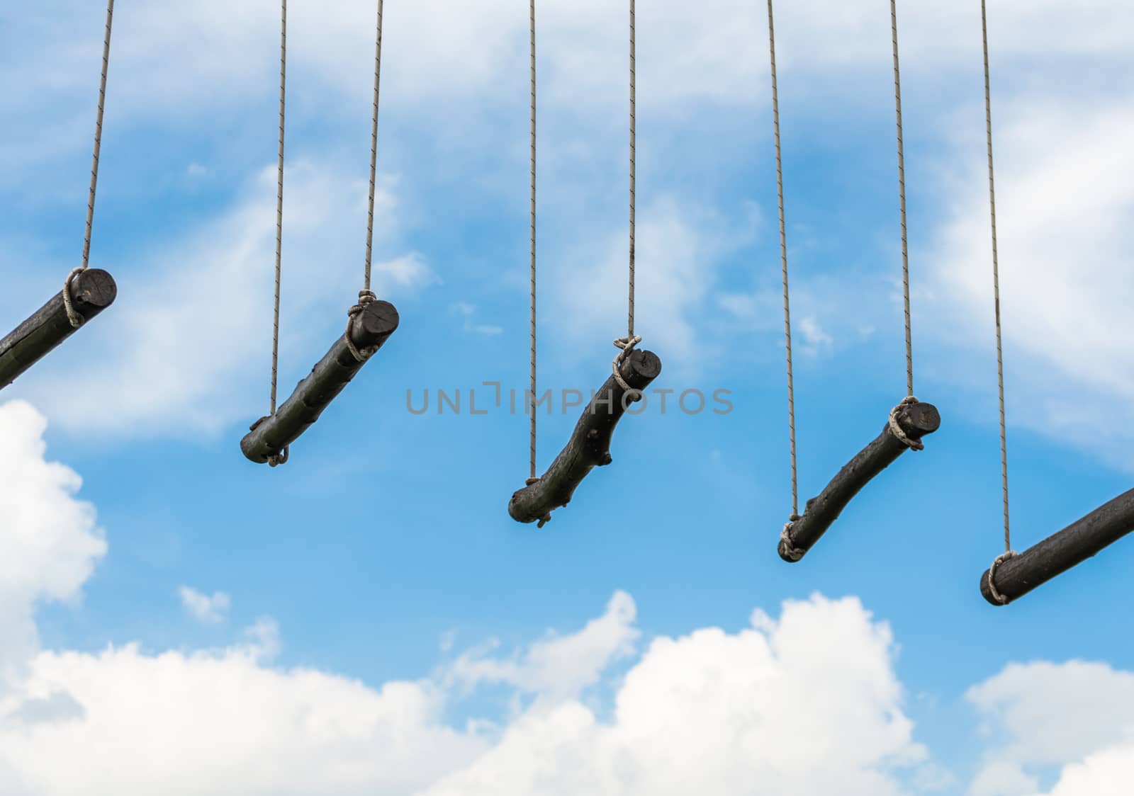 rope ladder against a blue sky and clouds