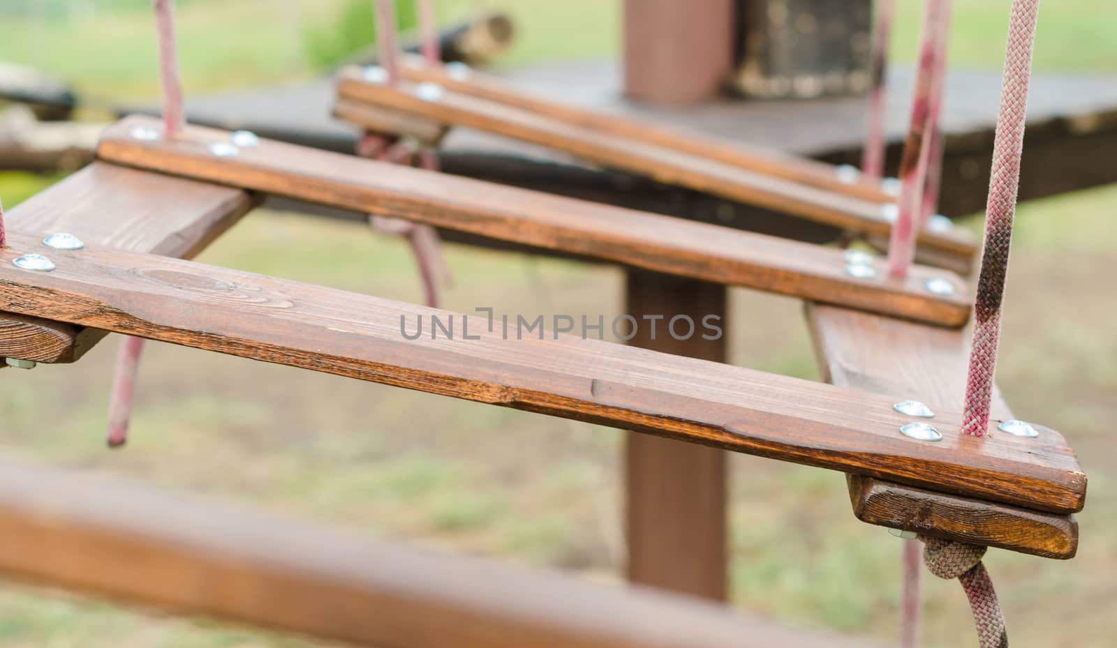brown fragment of a wooden suspension bridge close-up