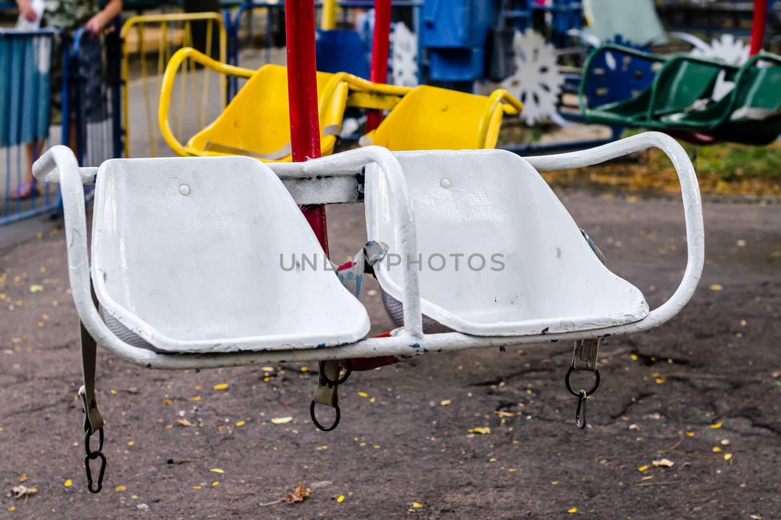 old white carousel seats in the amusement park