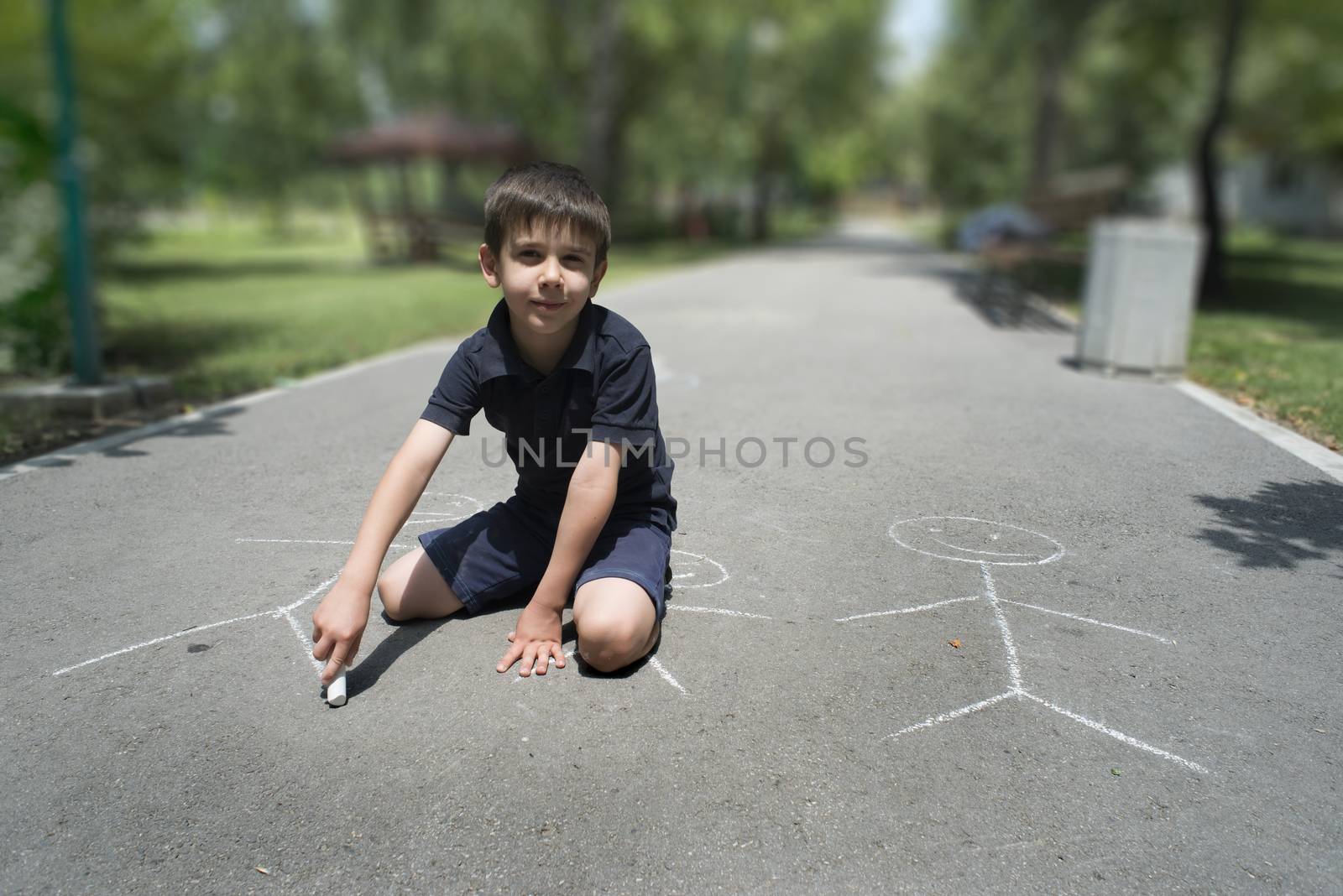 Child drawing family on asphalt by deyan_georgiev