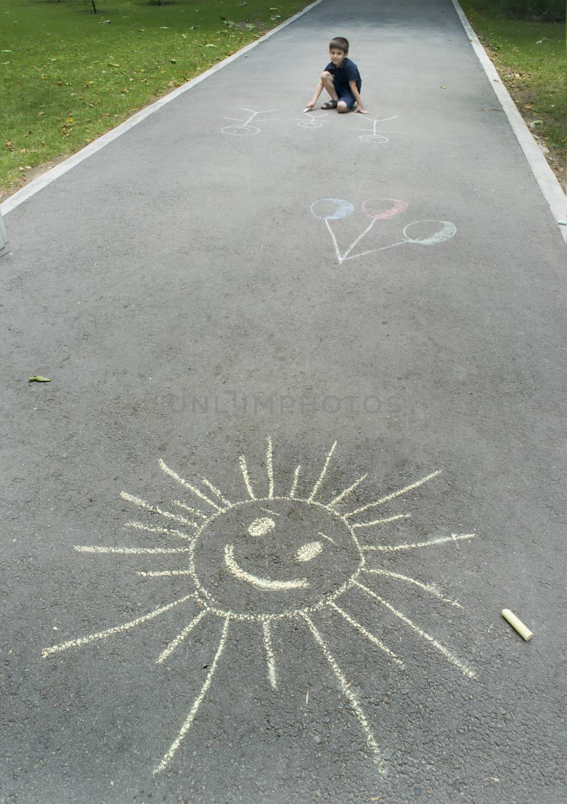 Child drawing on asphalt by deyan_georgiev