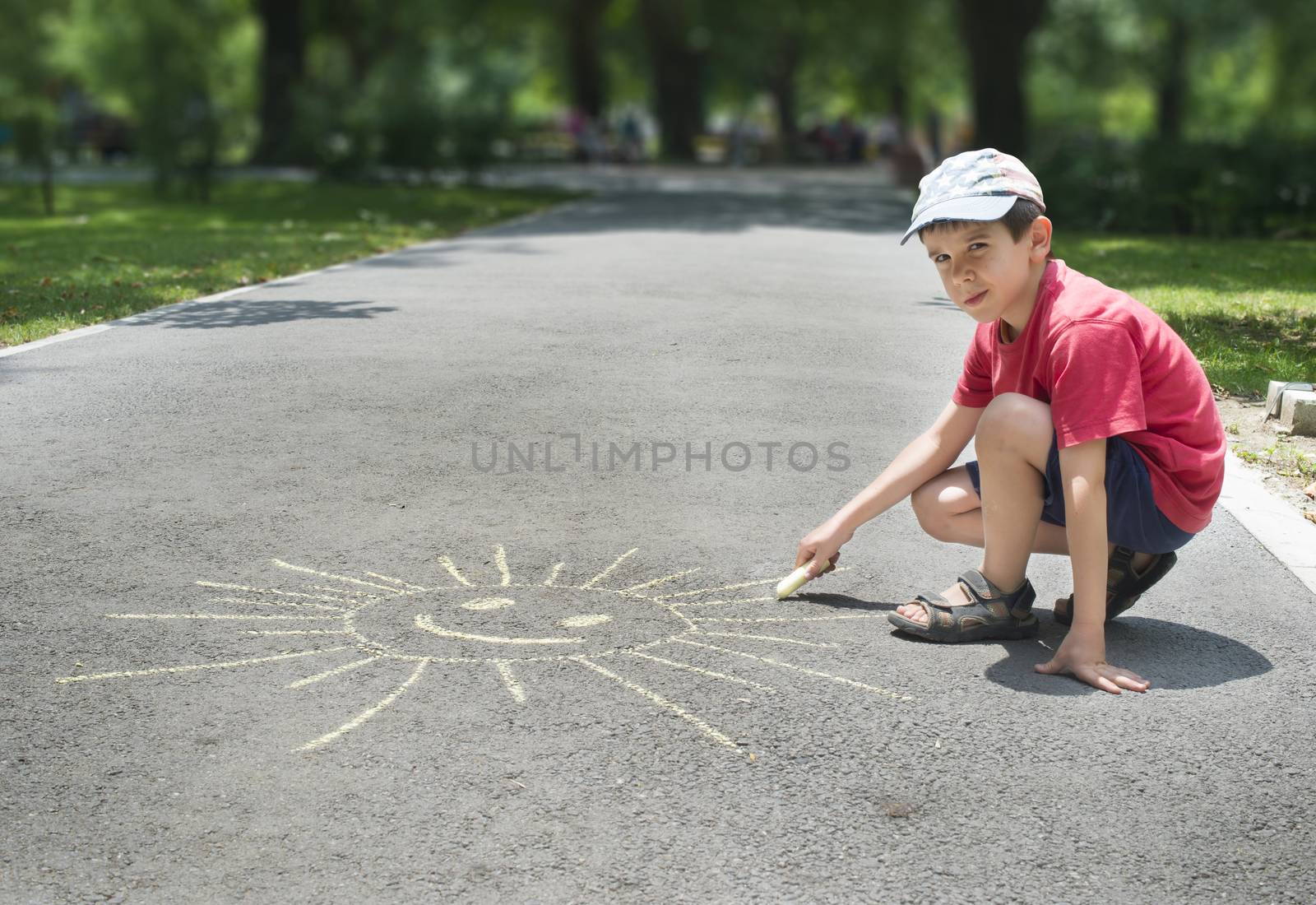Child drawing on asphalt by deyan_georgiev