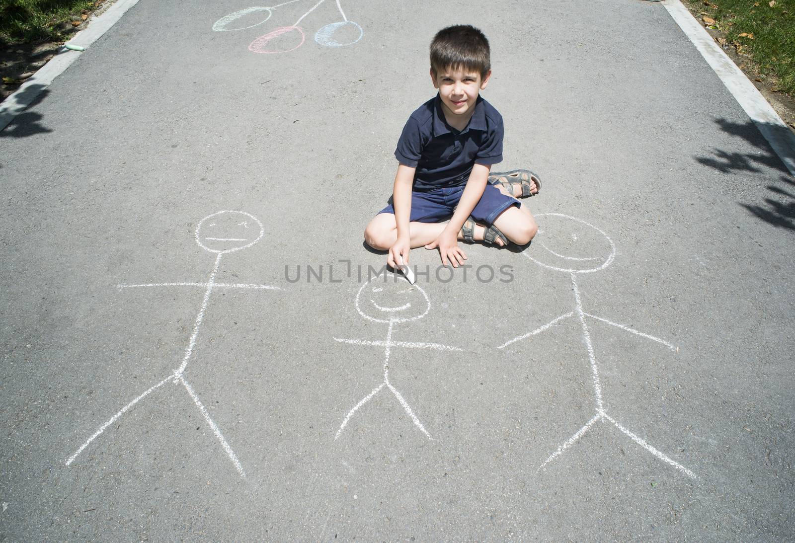 Child drawing family on asphalt by deyan_georgiev