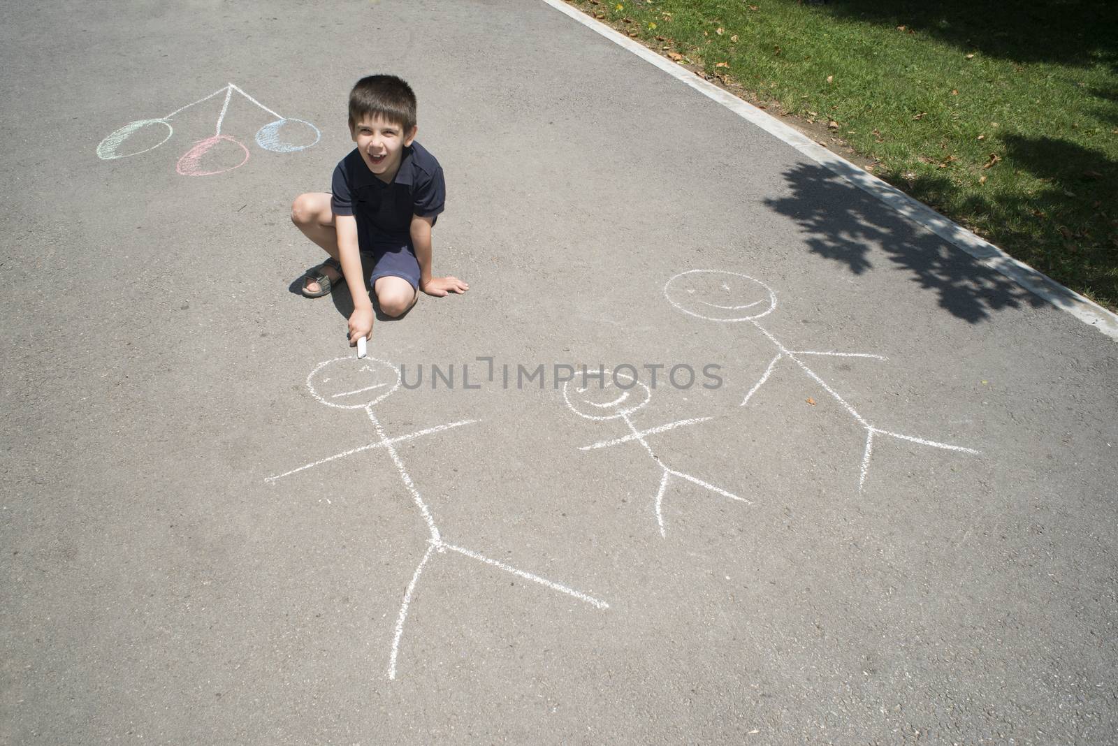 Child drawing family on asphalt by deyan_georgiev