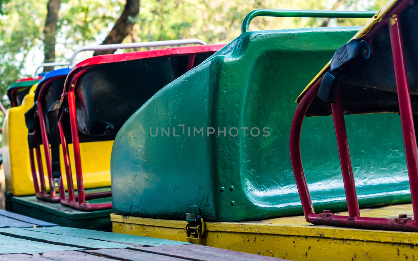 old multi-colored attraction trailers american roller coaster in amusement park