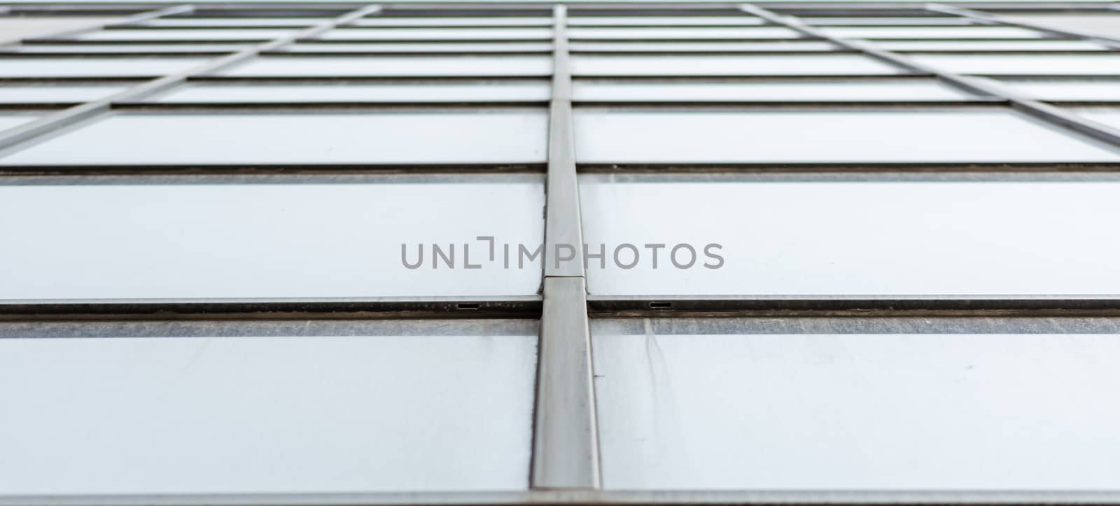 empty windows of a gray high concrete building