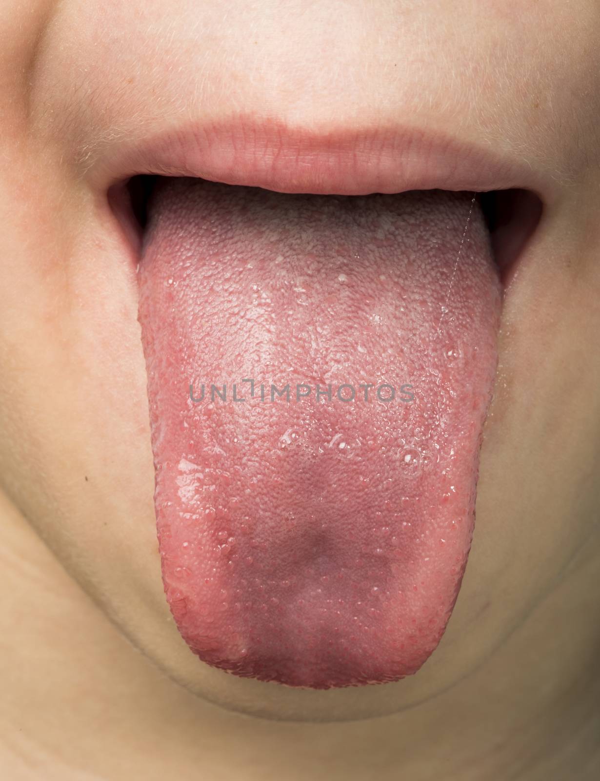 Human tongue protruding out. Child tongue.