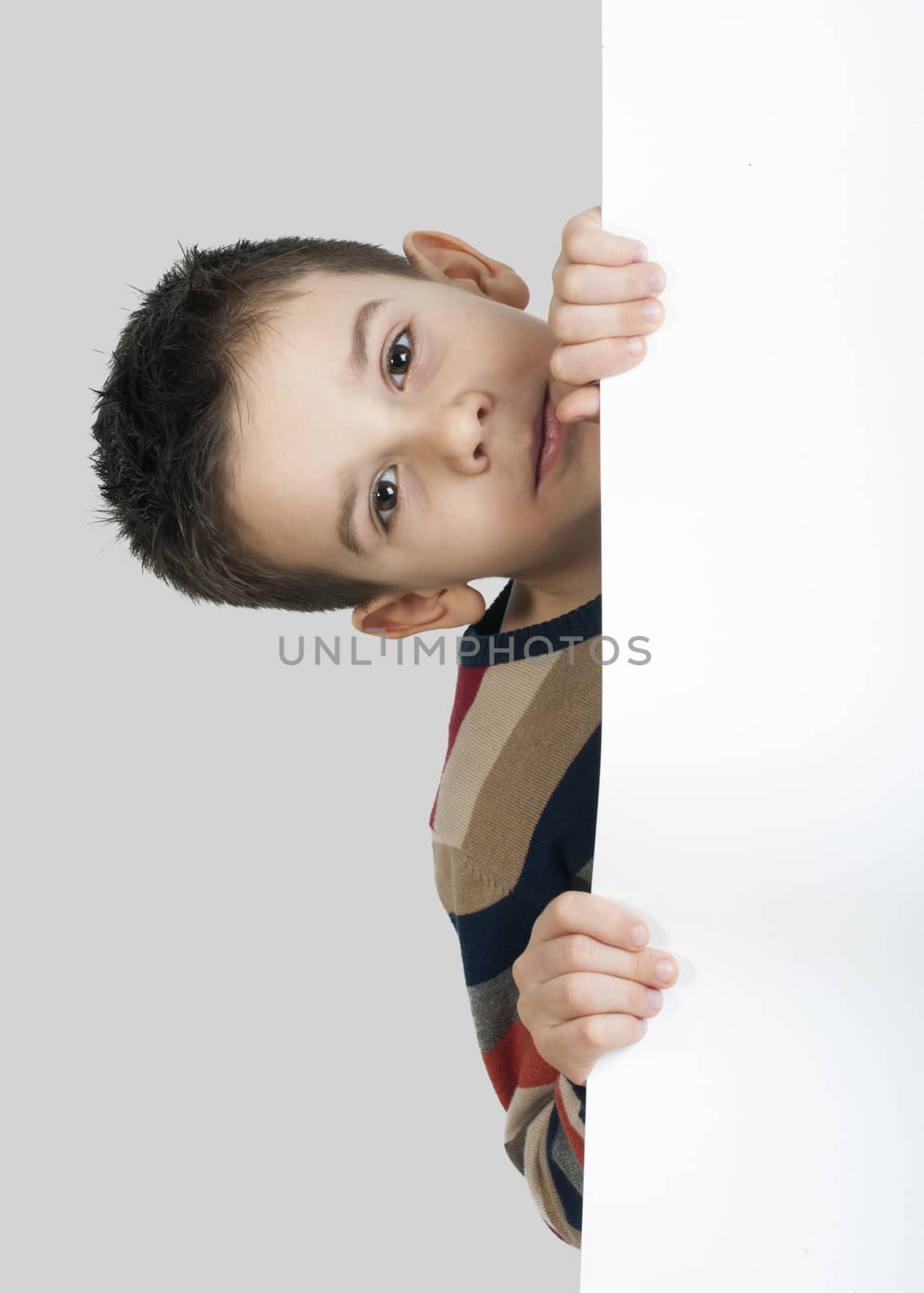 Little boy holding a whiteboard. White isolated studio shot