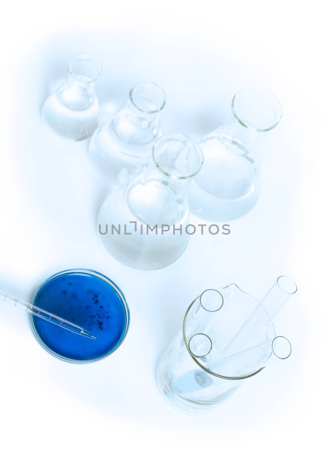 Laboratory glassware equipment. Laboratory beakers and blue liquid.
