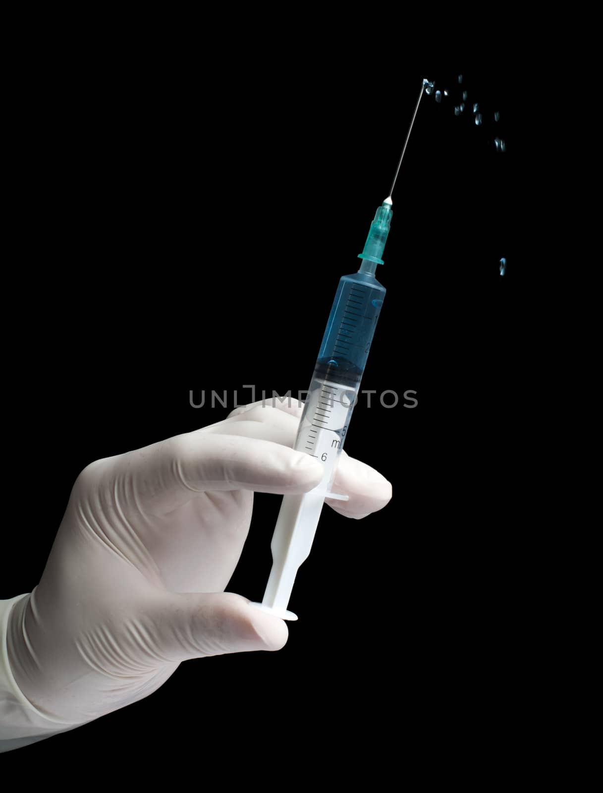 Hand hold medical syringe. Black isolated studio shot.
