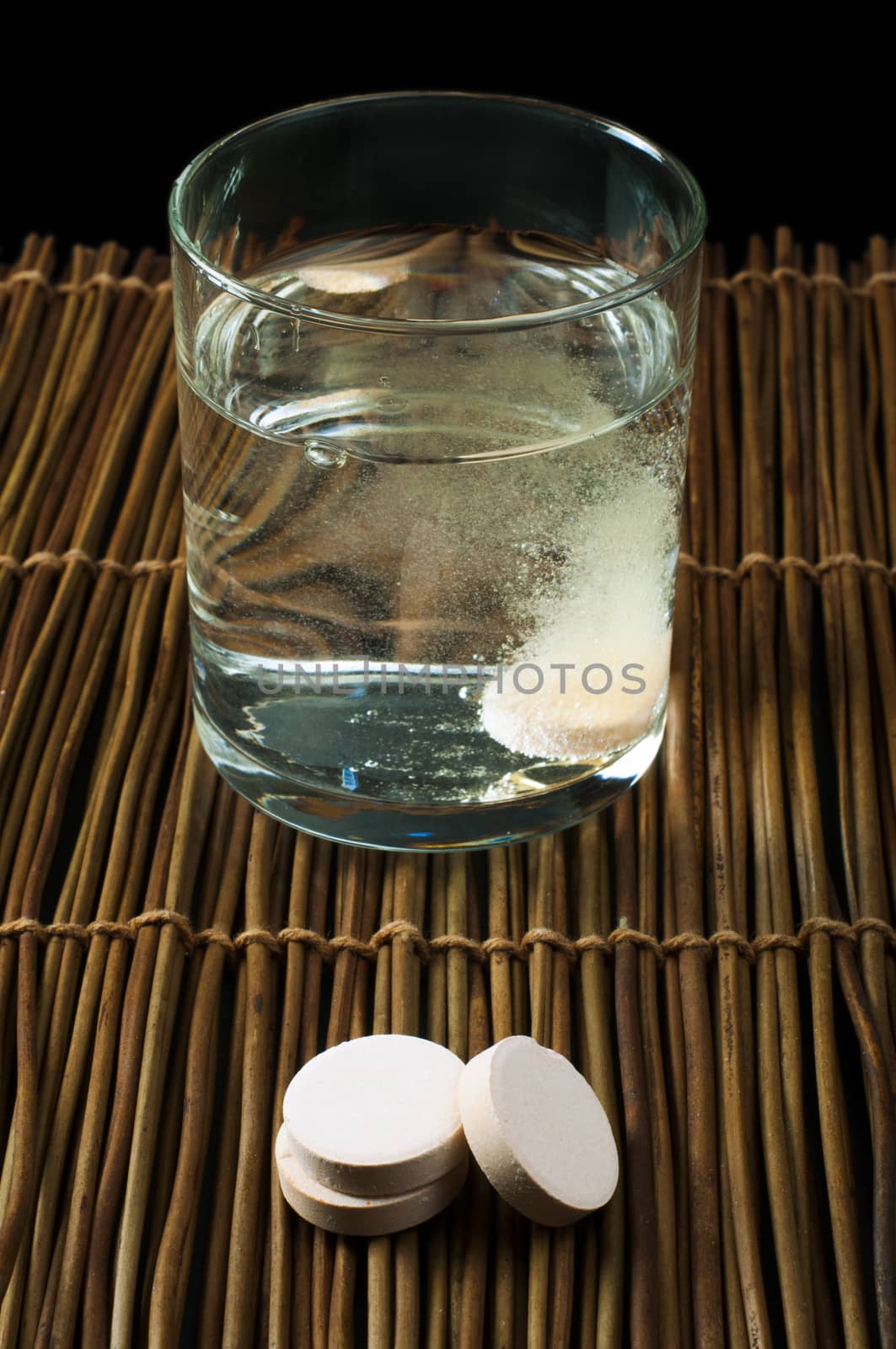 Water soluble aspirin. Glass of water and pills.