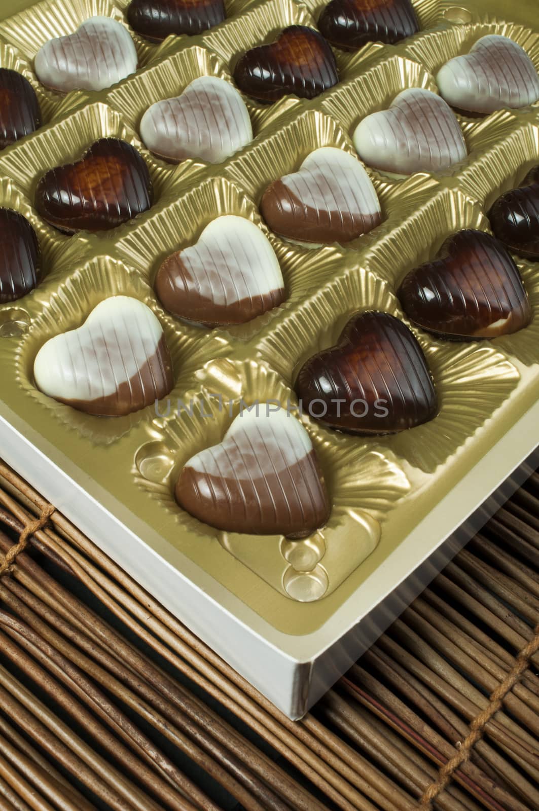 Chocolates in the shape of hearts. Chocolates in golden box.