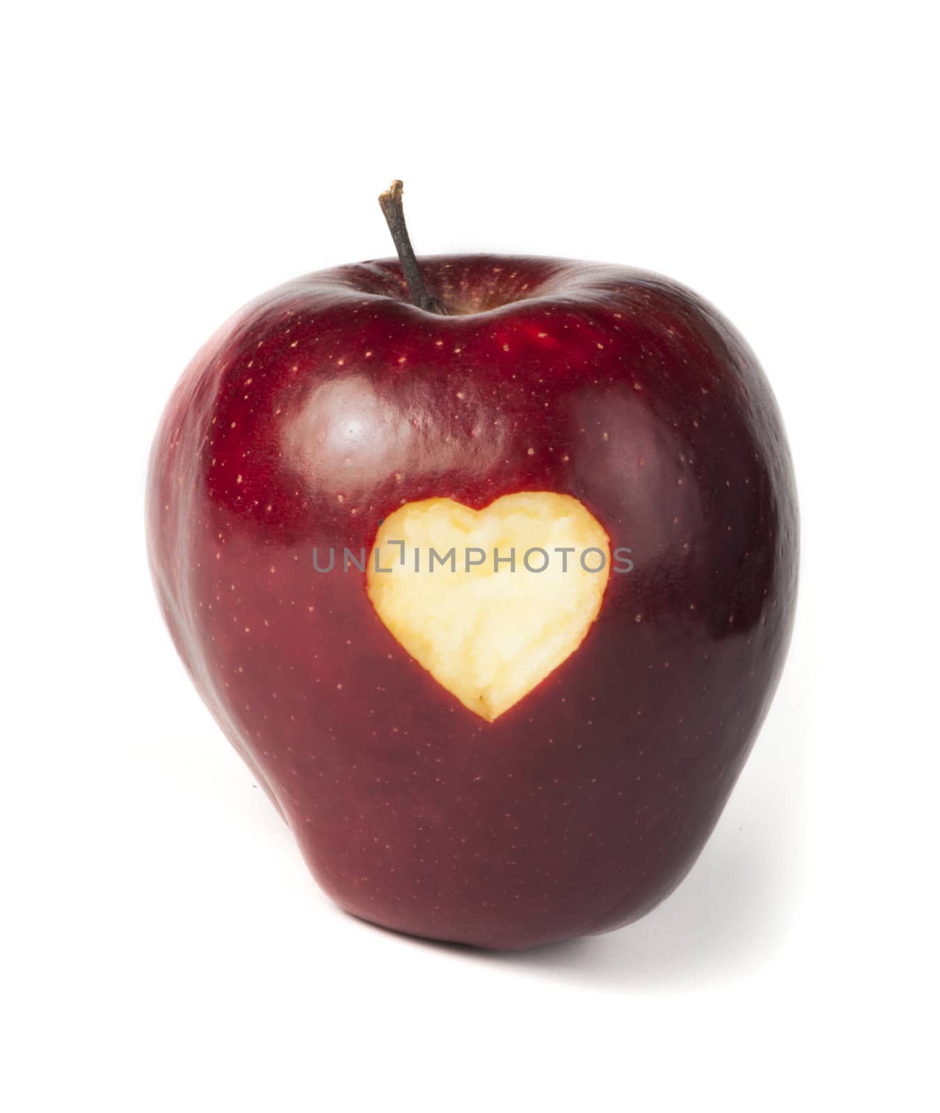 Heart shape closeup carved in red apple
