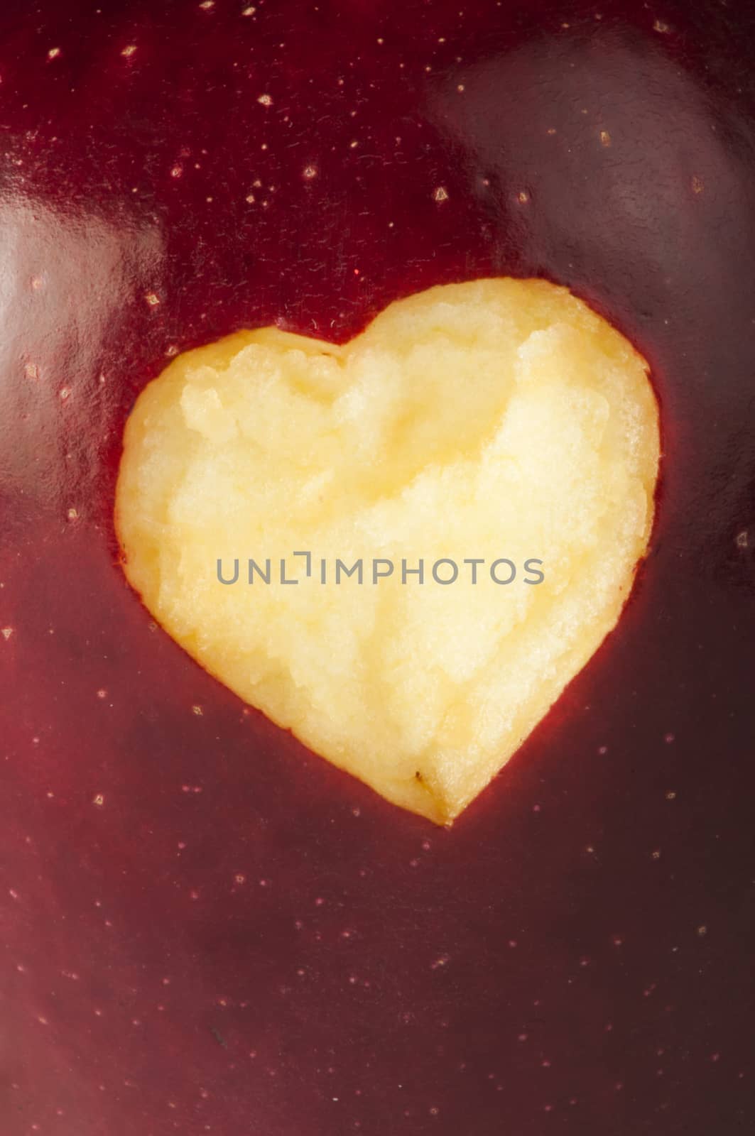 Heart shape closeup carved in red apple