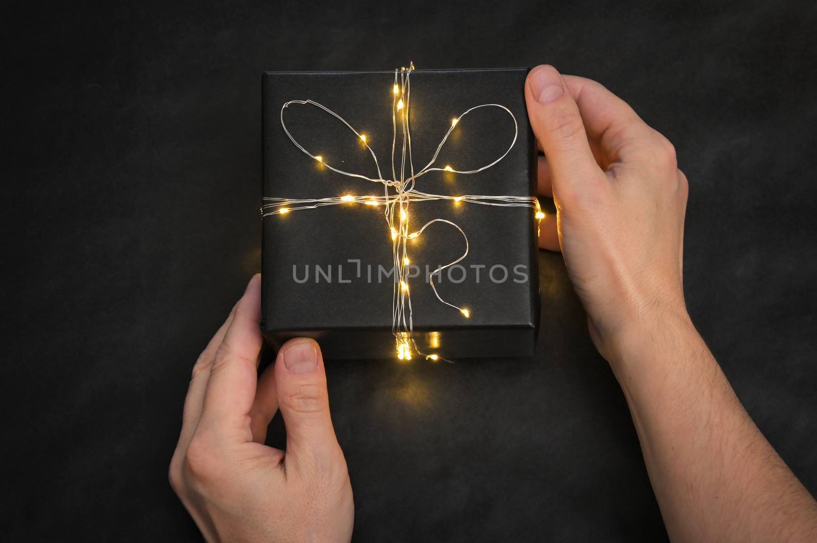 Black Present Box wrapped with string lights