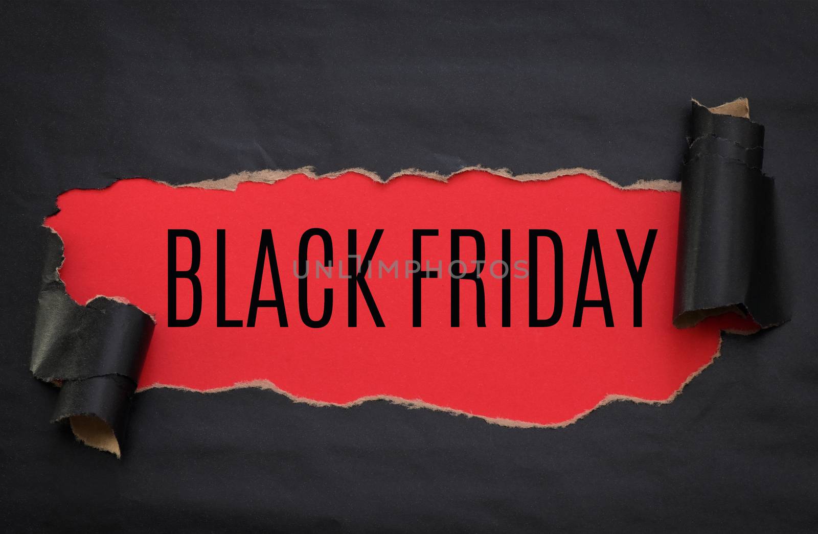 Black torn paper and text black friday on a red background