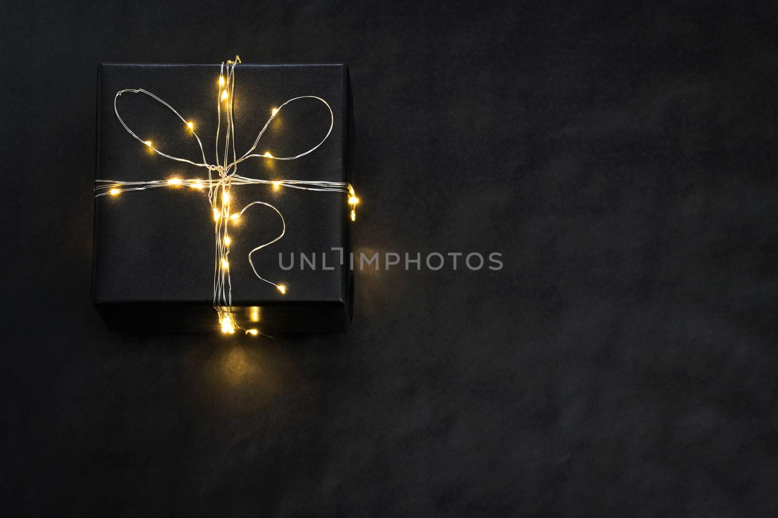 Black Present Box wrapped with string lights