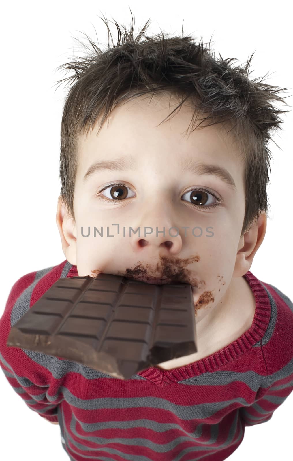 Smiling kid eating chocolate. Smeared stained with chocolate lips. White isolated