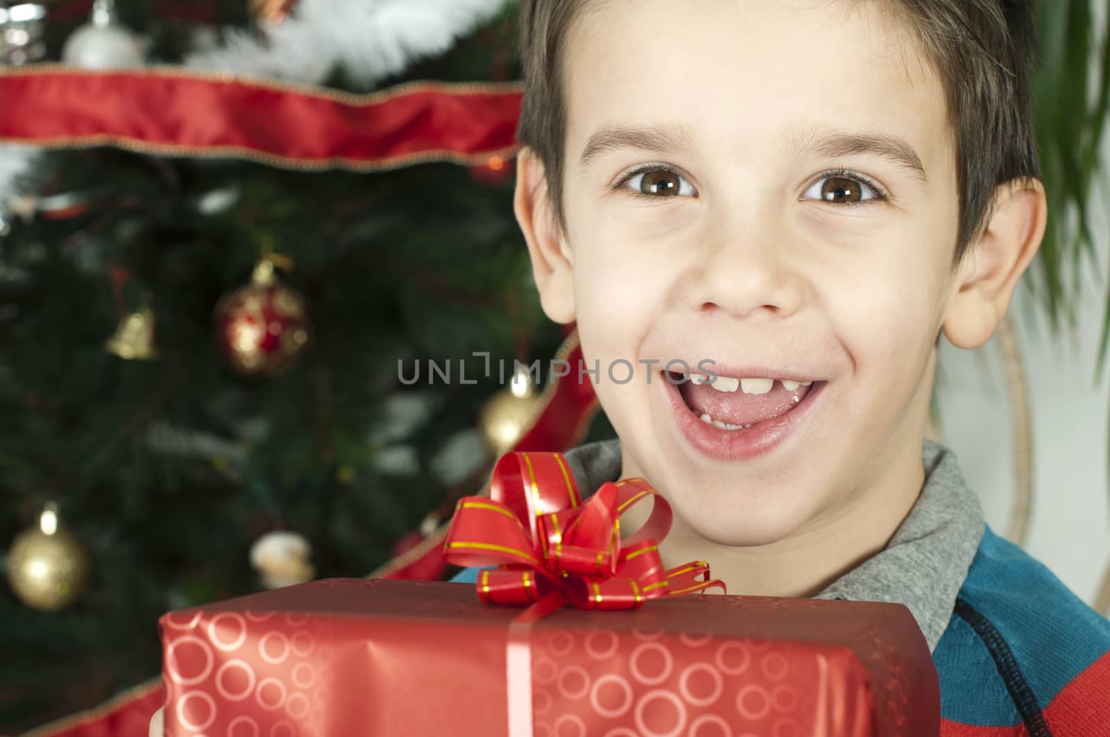 Happy child receive the gift of Christmas by deyan_georgiev
