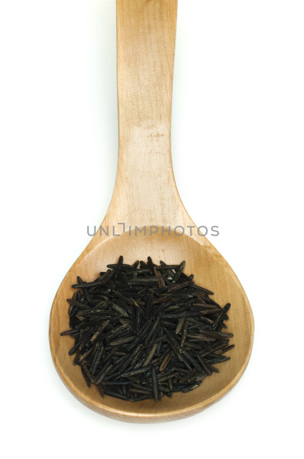 Wild black rice in wooden spoon on white background