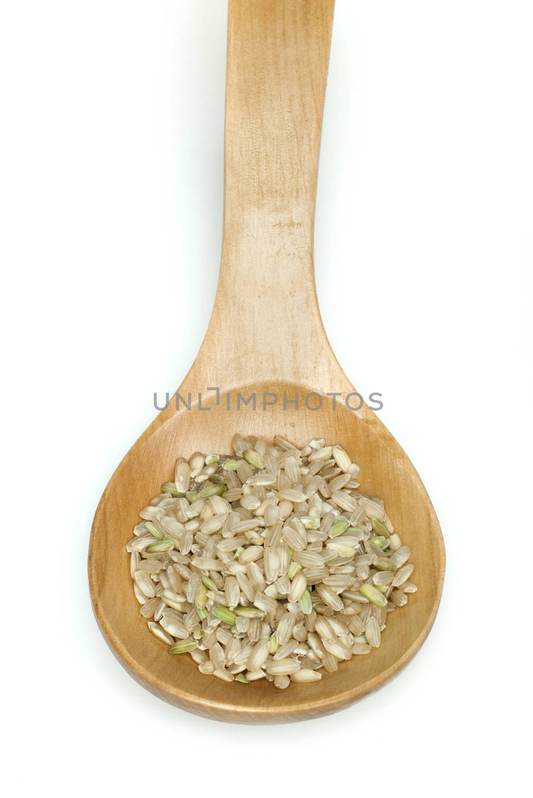 Rice integral in wooden spoon on white background