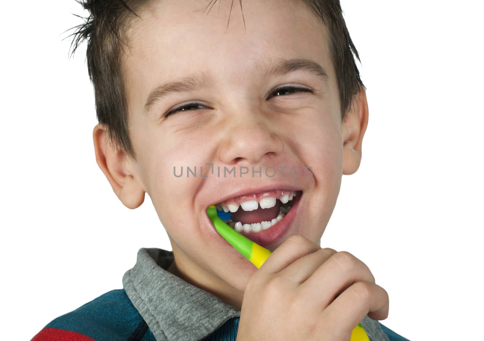Boy brushing his teeth. White isolated