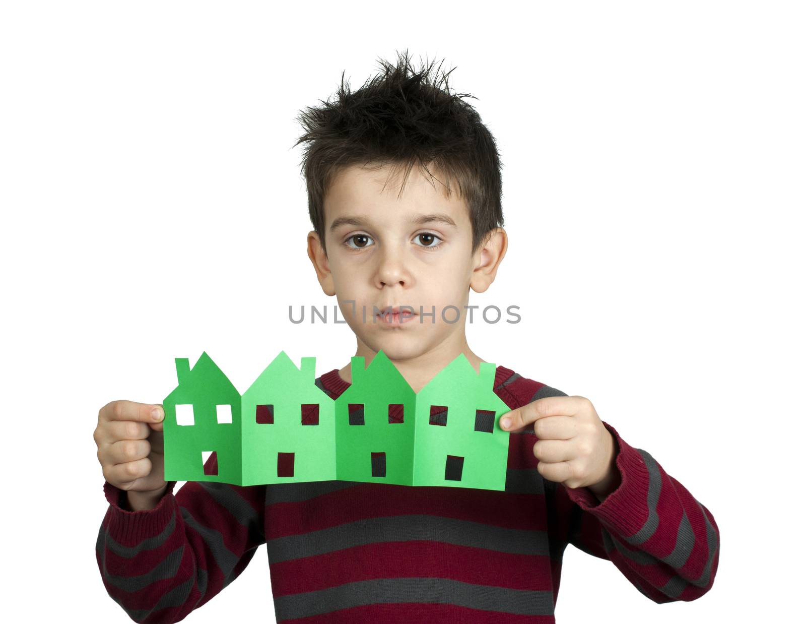 Little boy holding green houses made ​​of paper. White isolated