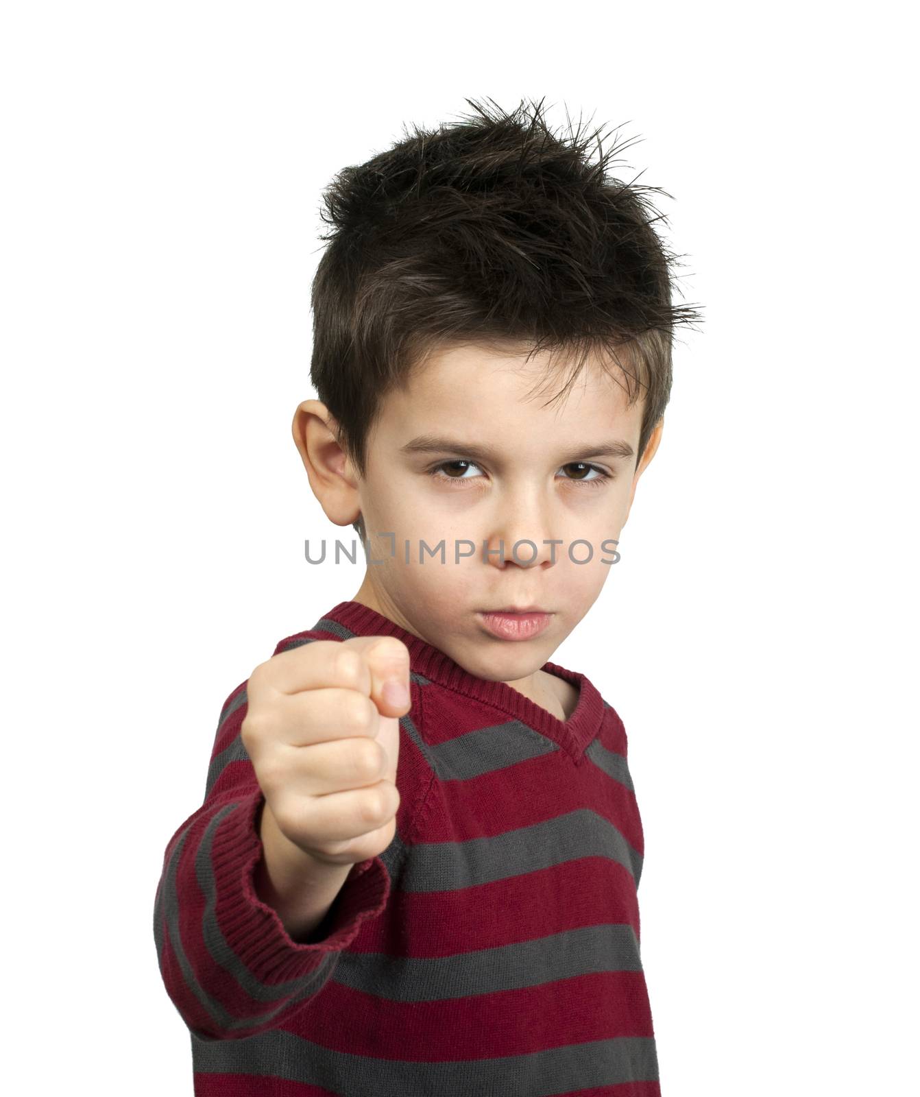 Little boy threatens with a fist to fight. White isolated