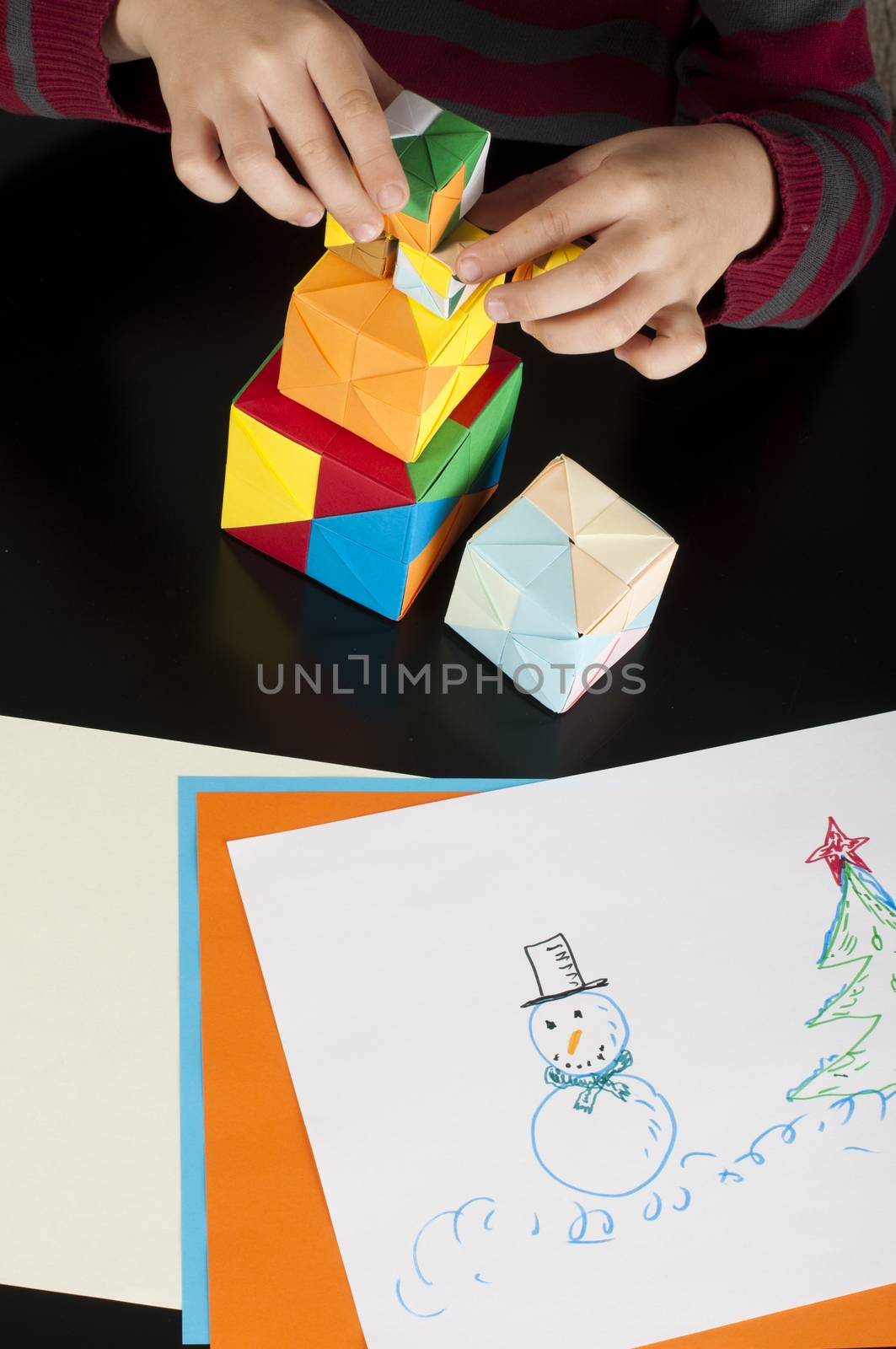 Boy playing with multicolored cubes by deyan_georgiev
