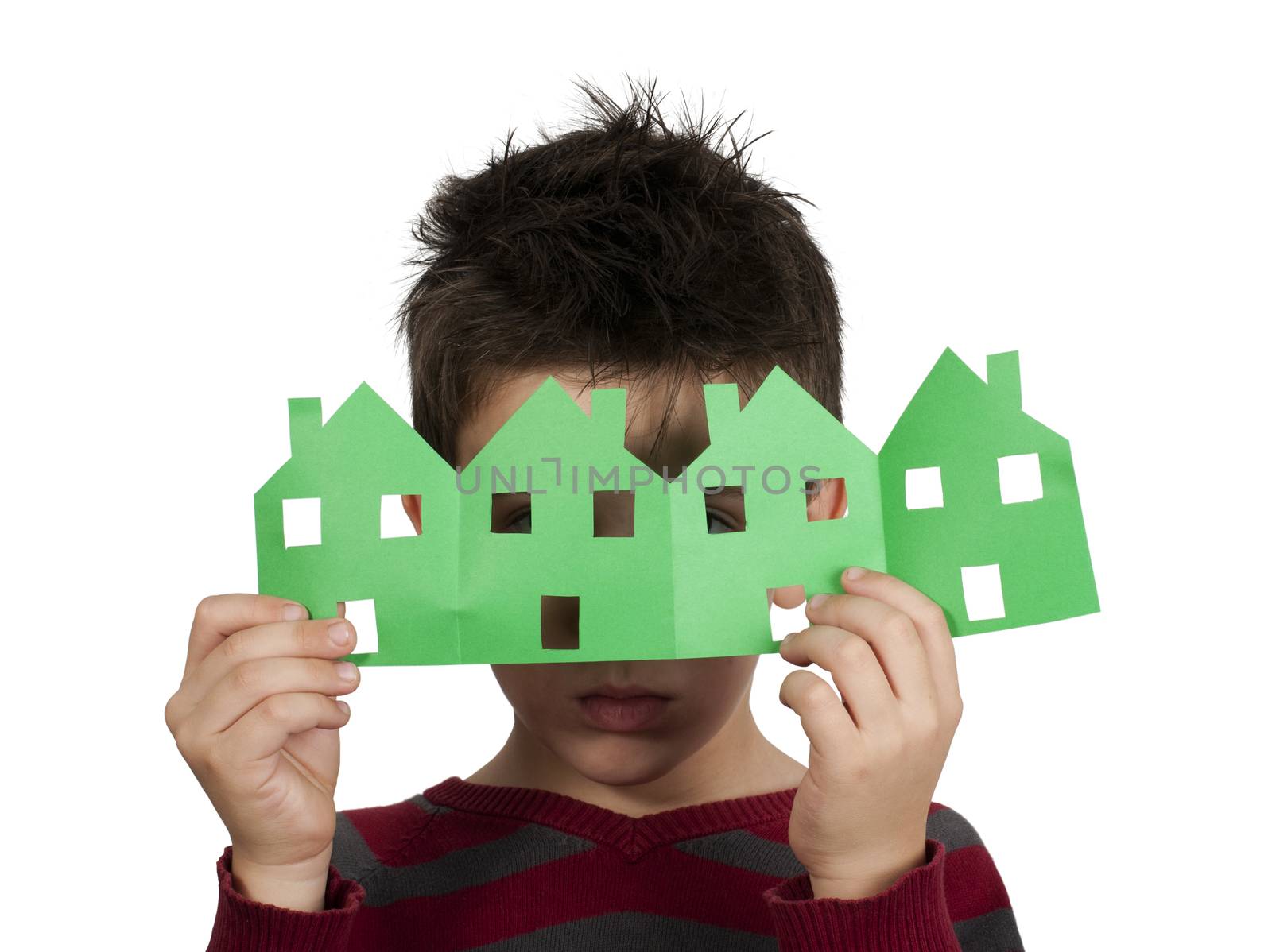 Little boy holding green houses made ​​of paper. White isolated