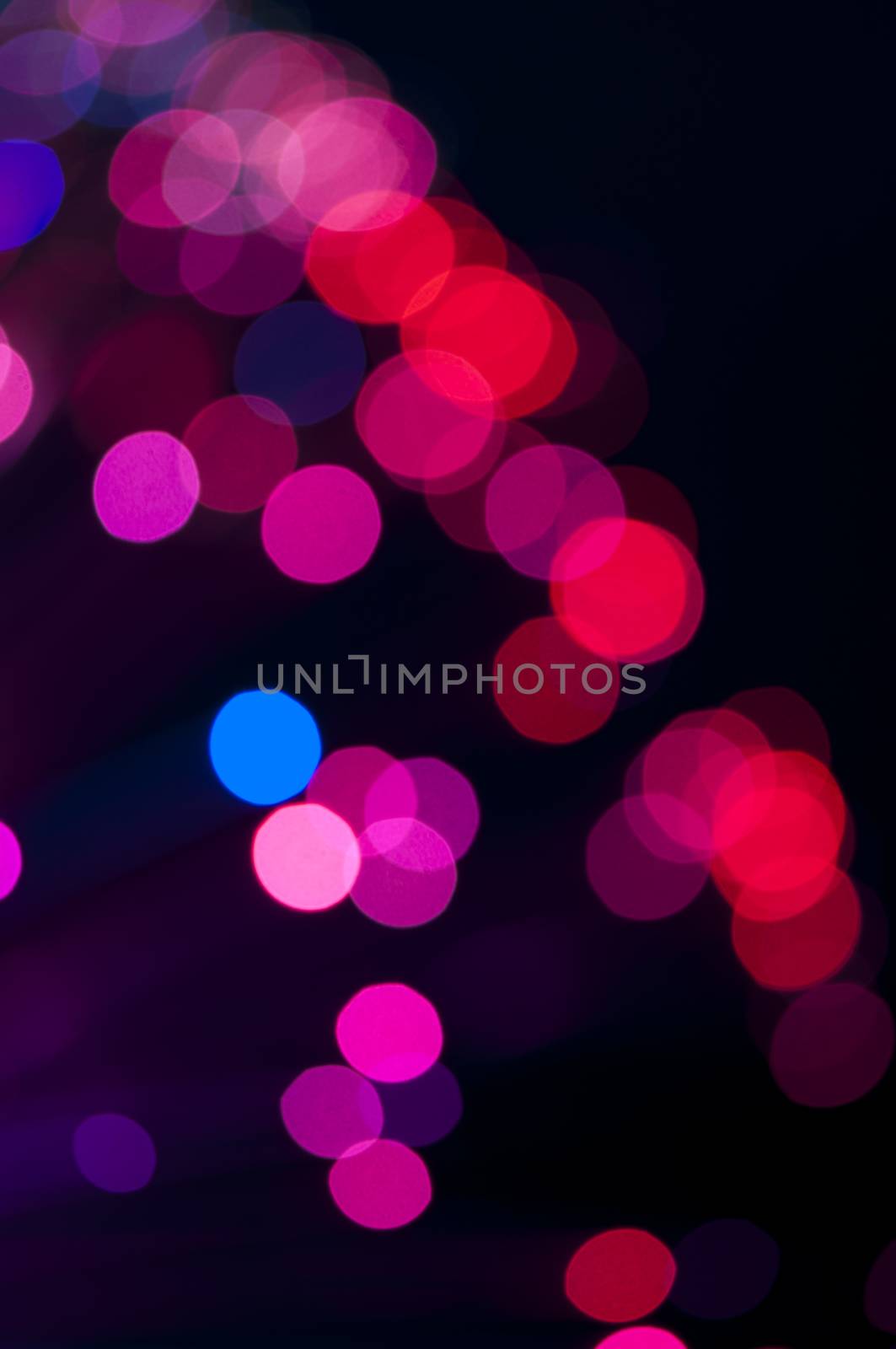 Blue and pink festive lights and circles background. Blurred christmas lights