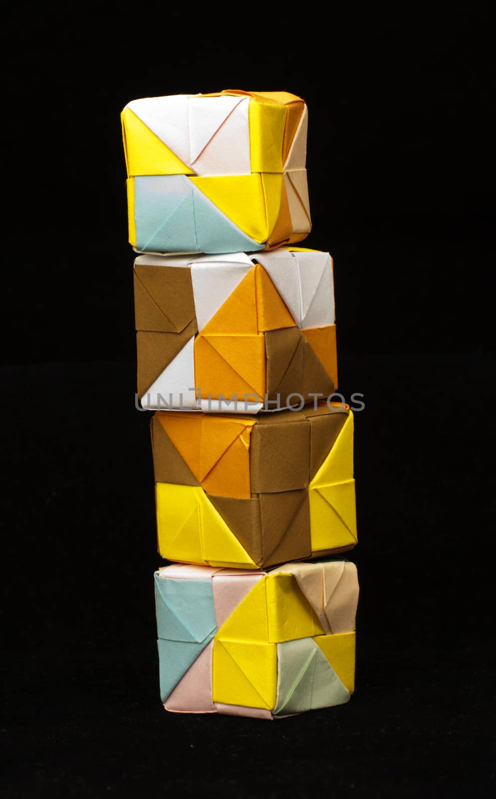 Paper made multi colored patterned cubes folded origami style.