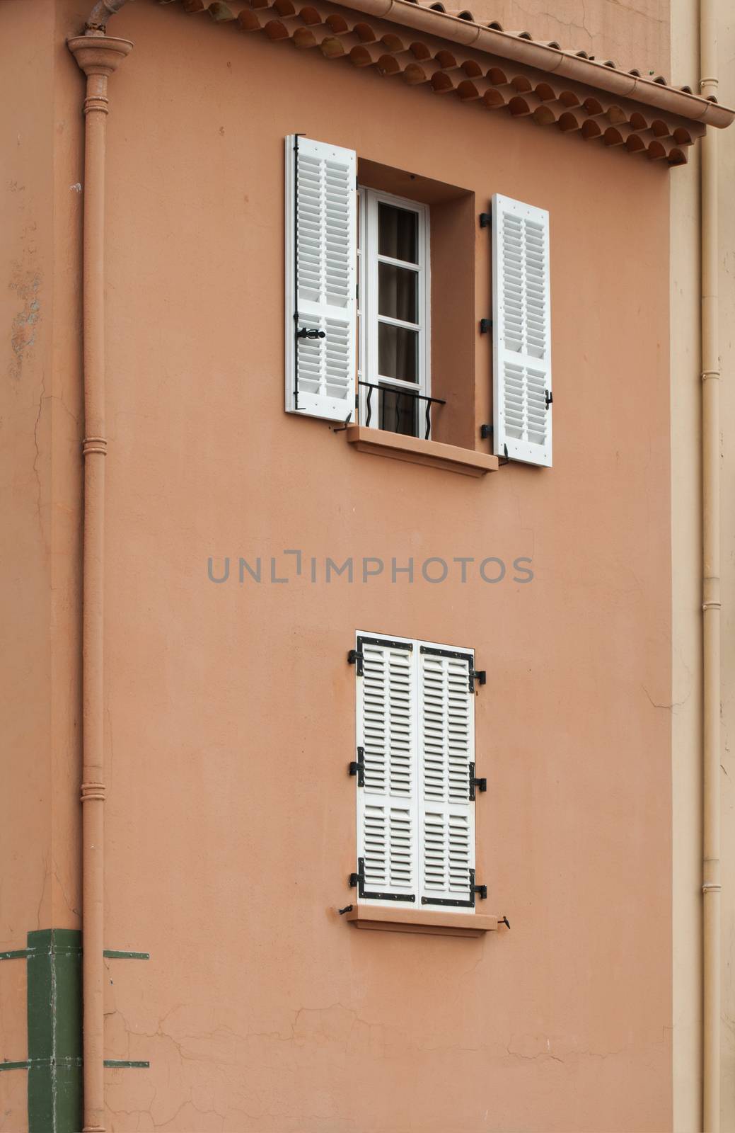 Ancient buildings in St. Tropez. Pink wall and windows