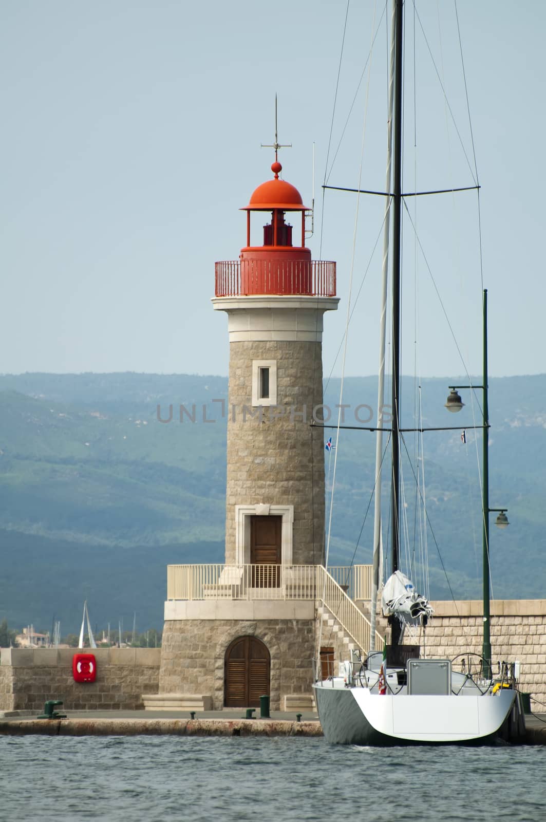 Port light in Saint Tropez and anchored boat