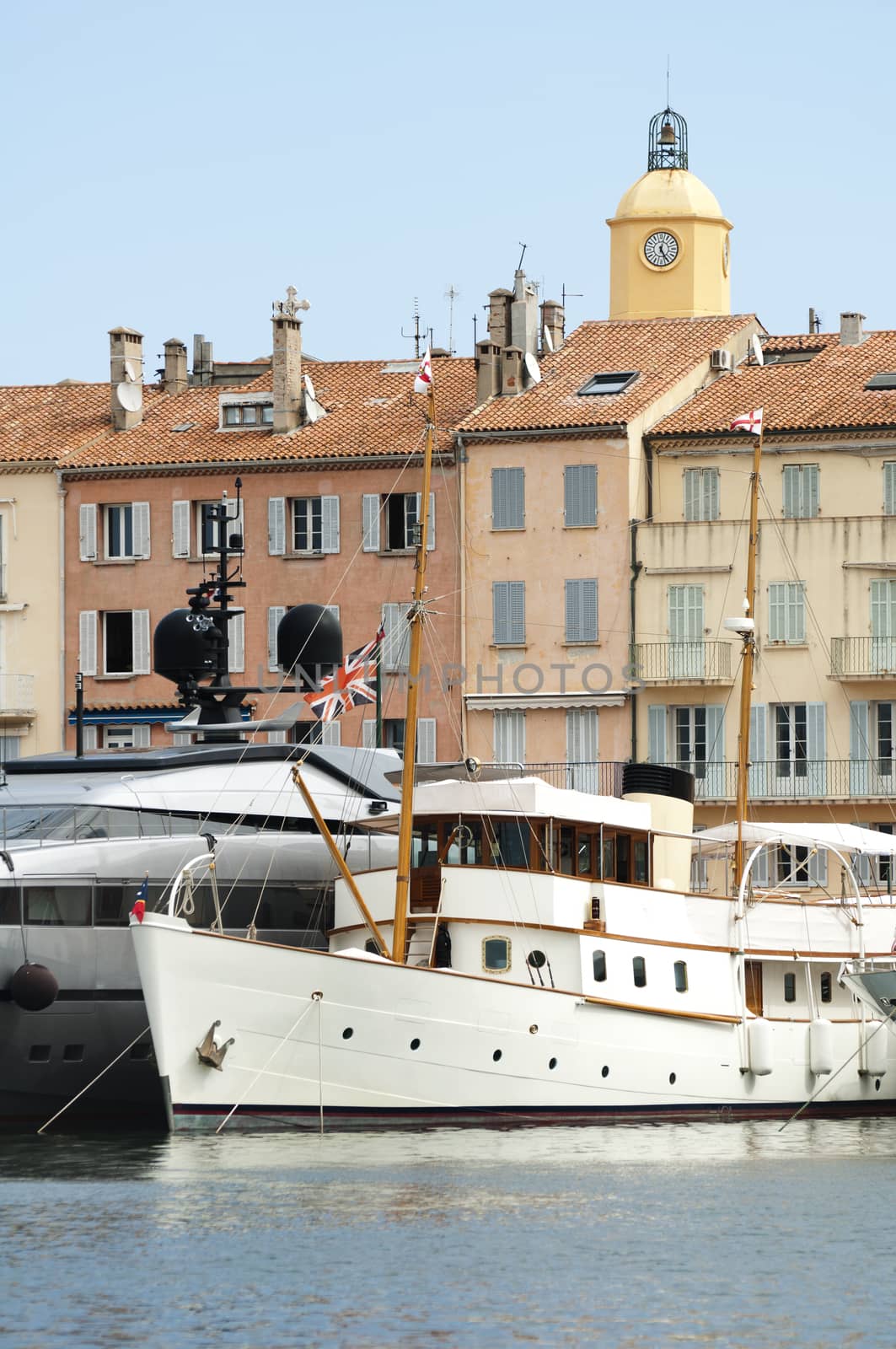 Anchored Yacht in St. Tropez. Ancient buildings on the background.