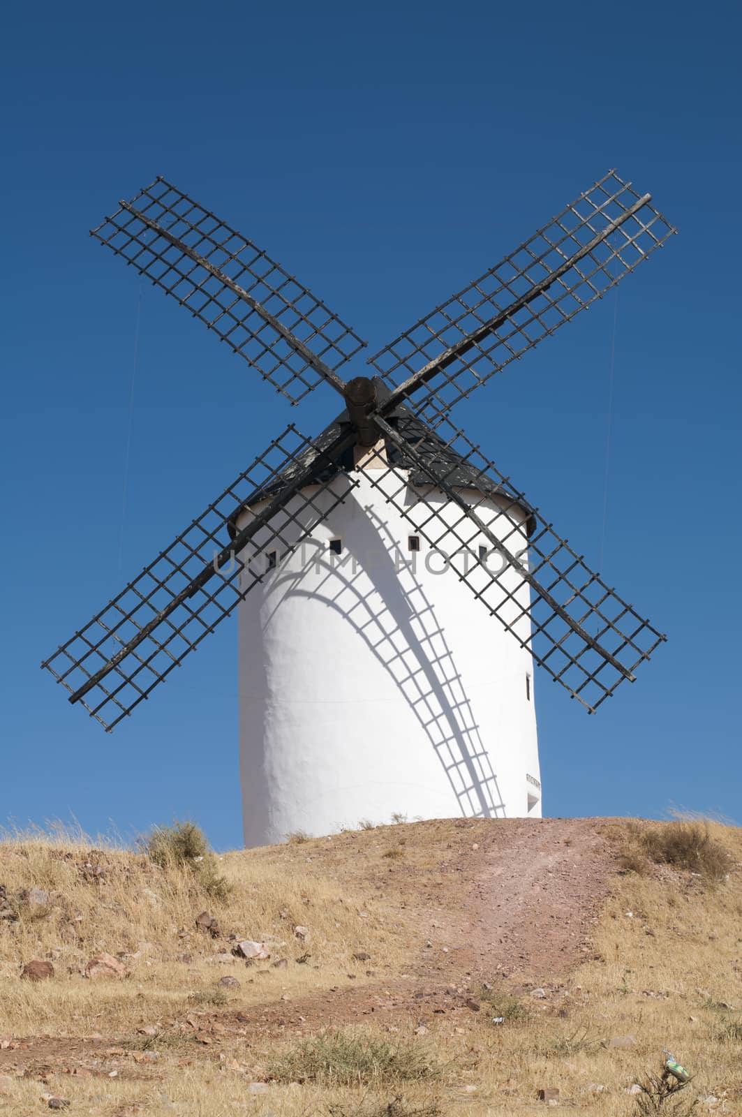 White ancient windmill. Blue sky background