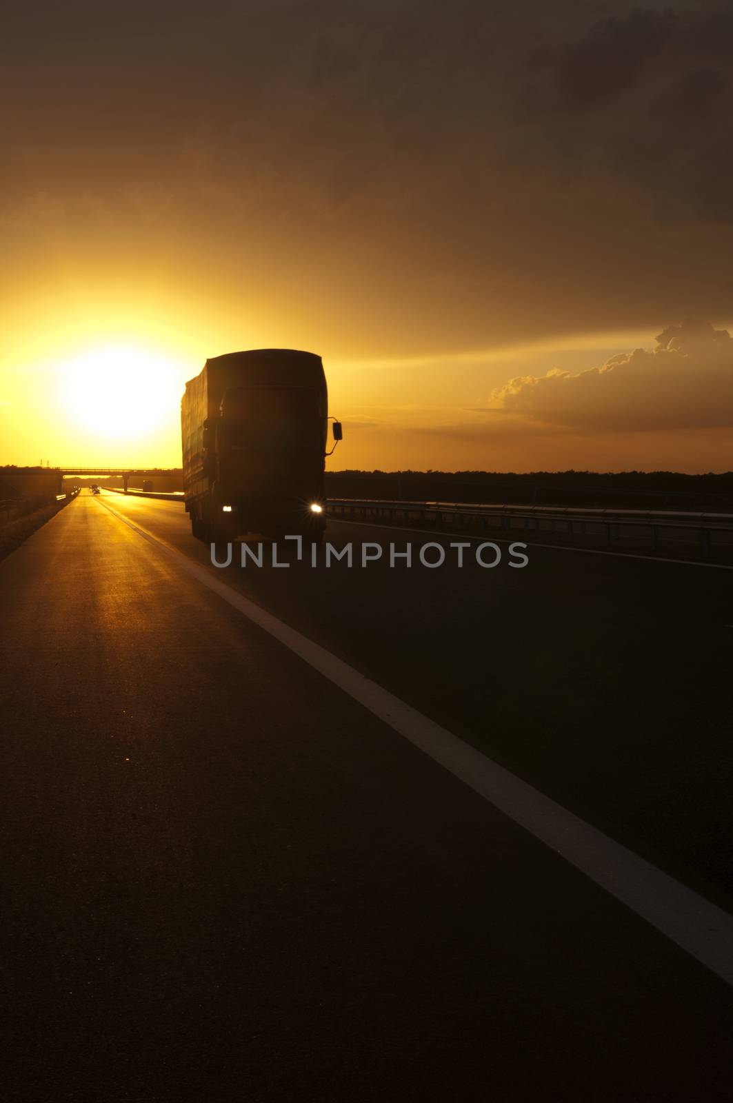 Truck traveling at sunset by deyan_georgiev