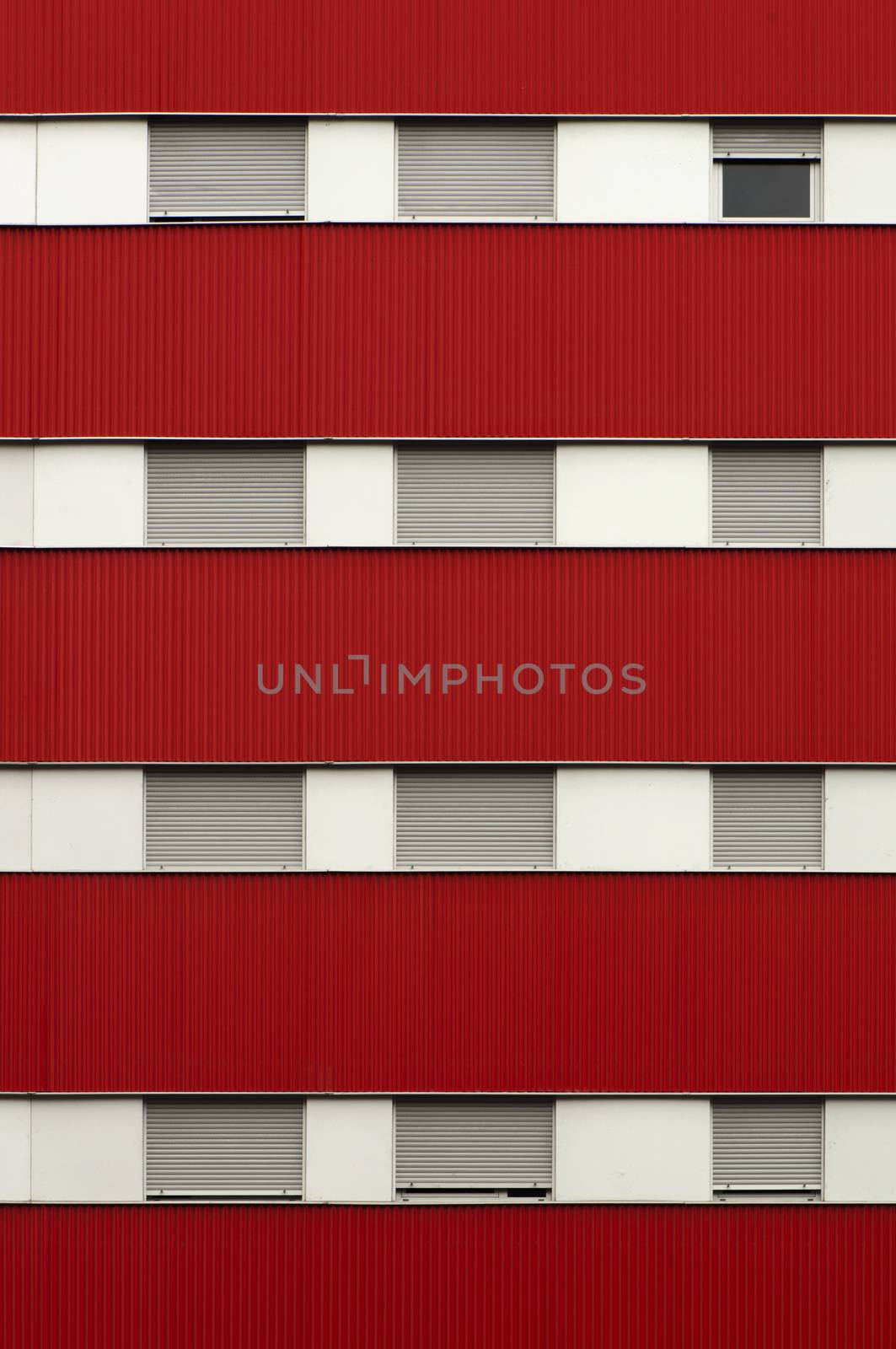 Red color facade and windows of a building.