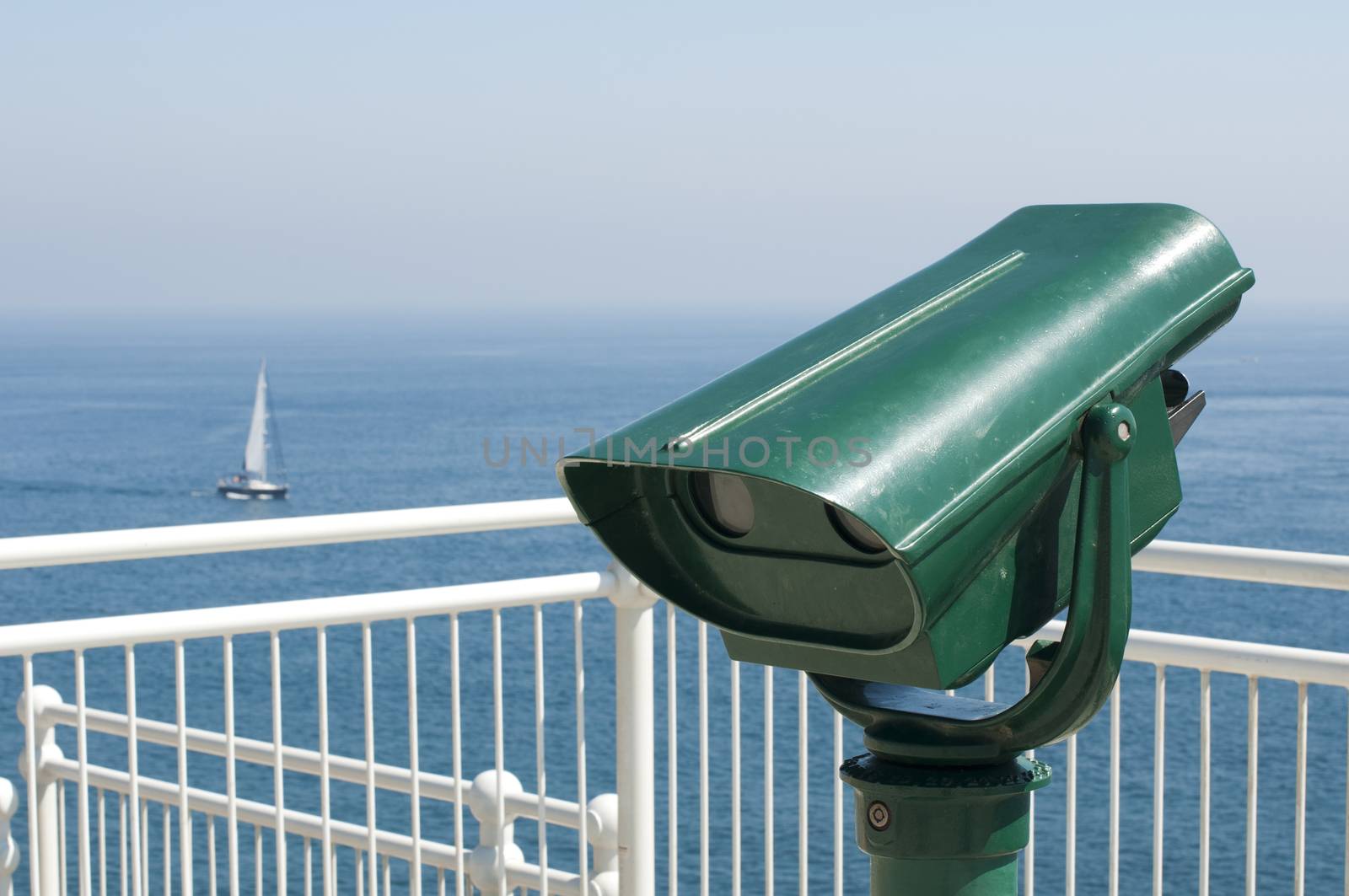 Green tourist telescope. Sea view and sky