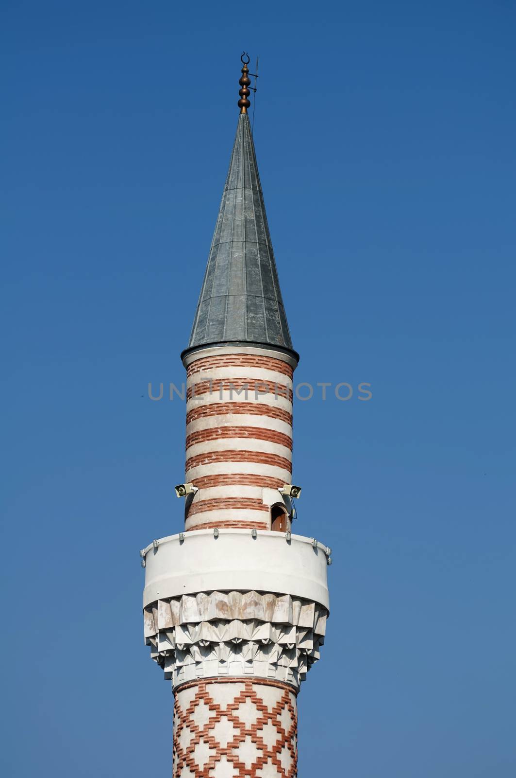 Minaret of the Mosque on blue sky background