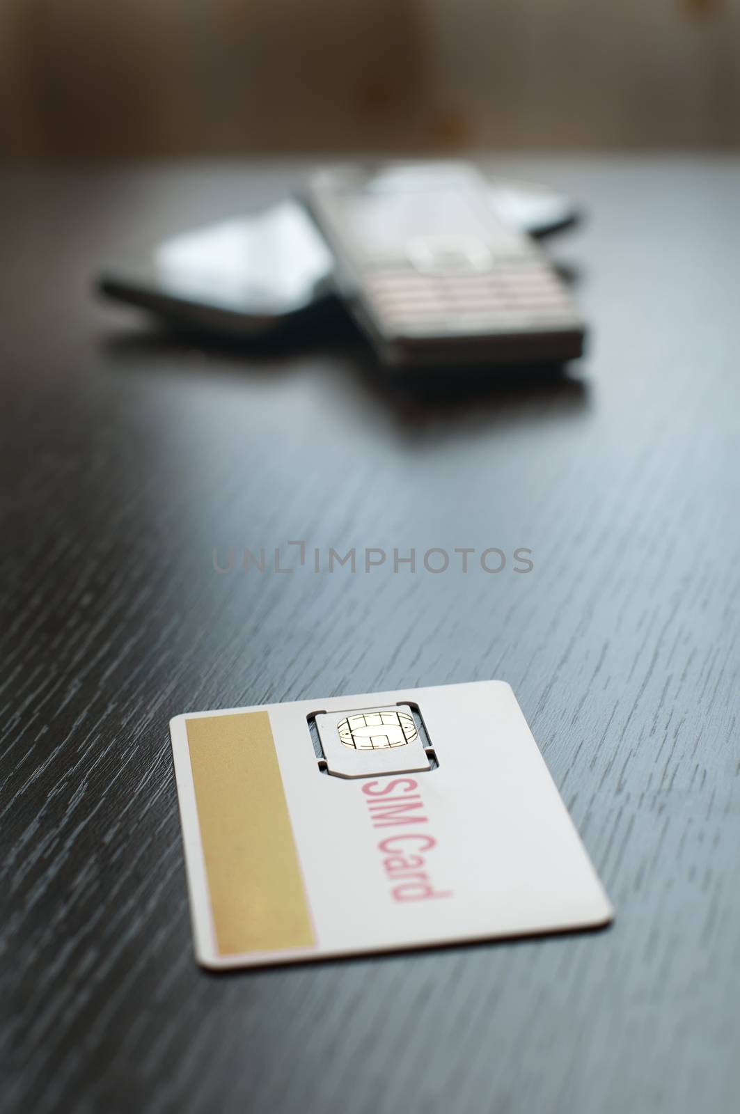 SIM card and mobile phone on table